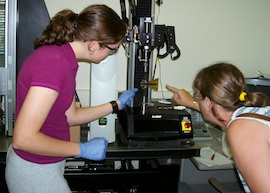 Mary shows a student how to load a frame